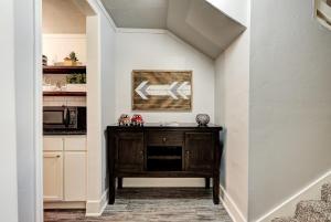 a hallway with a wooden cabinet in a kitchen at Indie Escape II-Stones throw to Plaza in Oklahoma City