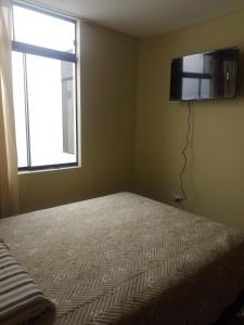Ένα ή περισσότερα κρεβάτια σε δωμάτιο στο Acogedora habitación