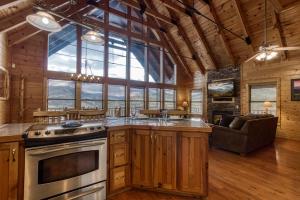a kitchen with a stove and a couch in a room at Hang Tenn in Sevierville
