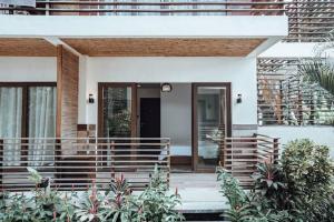 a house with a front porch with plants at Caracoa Resort in General Luna
