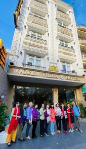a group of people standing in front of a hotel at Queen Villa Hotel 2 DL - by BAY LUXURY in Da Thien