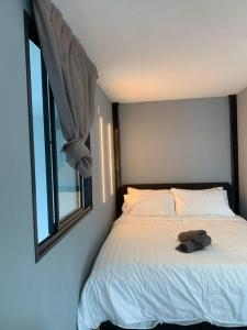 a bedroom with a bed with a hat on it at Damansara Empire Cozy Industrial Style 4 pax in Petaling Jaya