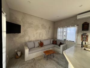 a living room with a couch and a table at Ocean View, Gorgeous Rooftop, AC, Wifi & Peaceful in Todos Santos