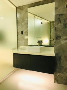 a bathroom with a sink and a mirror at Oyster Plaza Hotel in Manila