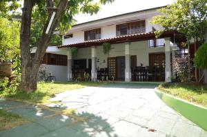 a building with a tree in front of it at Hotel Baltsol in Managua