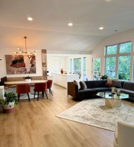 a living room with a couch and a table at Modern Home with private beach on St. Croix River in Lakeland