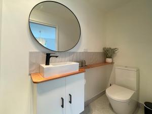 a bathroom with a sink and a mirror at Quarry House - Bright and Renovated! in Hobart +9 photos