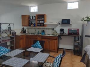 a kitchen with a table and a refrigerator at Lot # 7 ~ Large, Energetic Baja House in Guaymas