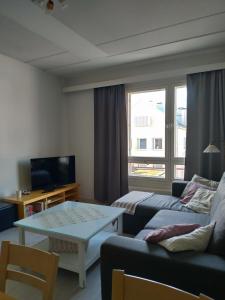 a living room with a couch and a table at City Apartments in Jyväskylä