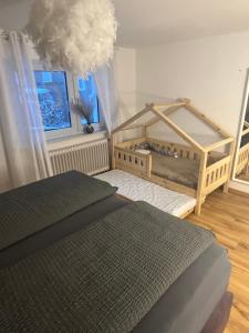 a bedroom with two beds and a large window at Ferienhaus Sauerland - Traum in Winterberg