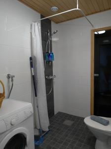 a bathroom with a shower and a washing machine at City Apartments in Jyväskylä +43 photos