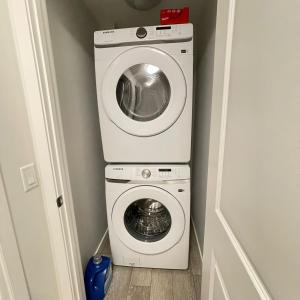 a washer and dryer in a small room at Exquisite Basement Suite, 7mins away to Landmark Cinema and Malls in Calgary