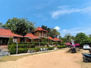 a house with a car parked in front of it at Sunrise Sea Hill Cottages in Karimunjawa