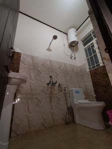 a bathroom with a toilet and a sink at SK Guest House in Shillong