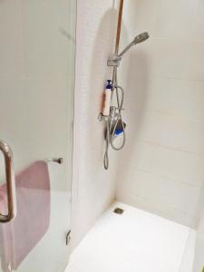 a shower with a shower head in a bathroom at Sunsky Patong beachfront House in Patong Beach