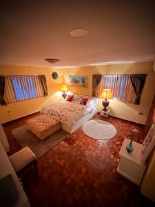 a bedroom with a large bed and two windows at Newly-renovated Modern Private Thai Villa with Swimming Pool in Ban Khlong Samrong +24 photos