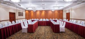 a conference room with tables and white chairs in it at Southern Sun Ridgeway Lusaka in Lusaka +77 photos