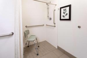 a small bathroom with a chair in a room at Country Inn & Suites by Radisson, Fargo, ND in Fargo