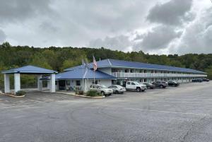 a large building with cars parked in a parking lot at Days Inn by Wyndham Renfro Valley Mount Vernon in Mount Vernon