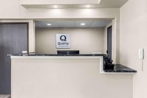 an office with a counter with a qualify sign on it at Quality Inn Oskaloosa in Oskaloosa