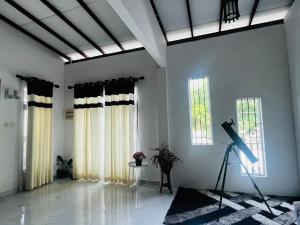 a room with white walls and windows with a camera at Cactus Boralesgamuwa in Boralesgamuwa