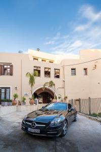 a luxury car parked in front of a building at Lithinon Luxury Suites with Free Parking in Chania Town