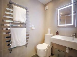 a bathroom with a toilet and a sink and a window at Carden Hill House - 4 Bedrooms - Sleeps 9 - Free Parking - Games Room - Ideal for Contractors, Families and Large Groups in Brighton & Hove +22 photos