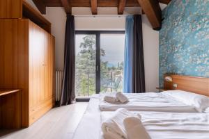 Postel nebo postele na pokoji v ubytování Hotel Al Castello