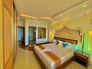 a bedroom with a large bed and a brick wall at Shanzu Two Bedroom Coastal Getaway in Mombasa +41 photos