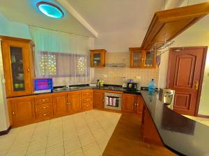 a kitchen with wooden cabinets and a counter top at Shanzu Two Bedroom Coastal Getaway in Mombasa
