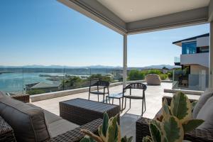 a patio with furniture and a view of the water at Eagles Nest in Knysna