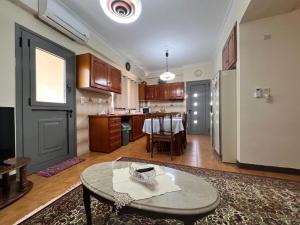 a living room with a table and a kitchen at The Captain's Nest in Sparta