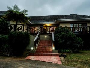 a house with a staircase in front of it at Buffalo View Lodge in East London