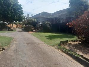 a house with a brick driveway in front of it at Buffalo View Lodge in East London +2 photos