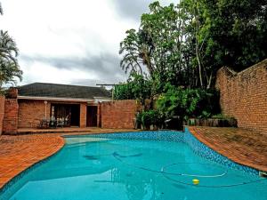 a swimming pool in the yard of a house at Buffalo View Lodge in East London