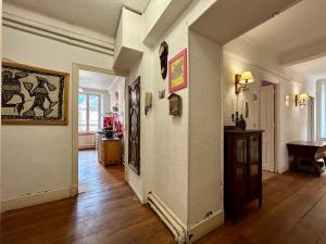 a living room with a hallway with at Evasion Authentique - Centre ville - Jeux de société in Barcelonnette