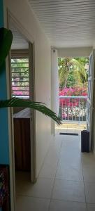 a hallway with an open door to a balcony at L'appartement de la plage in Le Diamant +5 photos