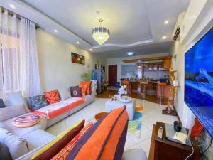 a living room with a couch and a large aquarium at Two Bedroom Apartment in Mombasa
