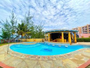 a large swimming pool with a gazebo at Two Bedroom Apartment in Mombasa