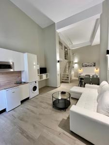 a living room with a white couch and a table at Ribera Suites GP in Córdoba