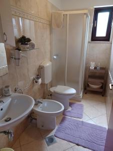 a bathroom with a toilet and a sink at Room Pometo III in Poreč