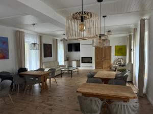a large living room with tables and chairs at Tkalcovna U Zlatého potoka in Dobřany