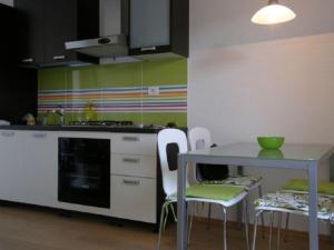 a kitchen with a table and a table and chairs at Apartments Rusulica in Vinišće