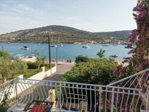a view of a beach with boats in the water at Apartments Srdan in Vinišće