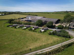 an aerial view of a farm with buildings and a road at Grassington Farm by Wigwam Holidays in Helston +3 photos