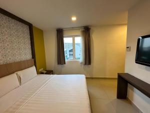 Postel nebo postele na pokoji v ubytování South of The Clouds HOTEL KL Sentral 吉隆坡彩云之南酒店-中央车站店