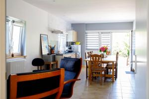 a kitchen and dining room with a table and chairs at le petit gite de Marinette in Villers-Robert