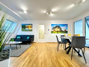 a living room with a table and a couch at Auszeit Apartment LAKELIFE in Friedrichshafen