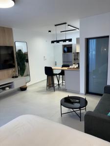 a living room with a couch and a table at Boutique Suite Tal in Eilat