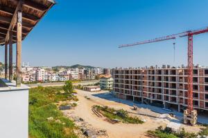 an apartment building under construction with a crane at Summer Apartments D&A in Golem